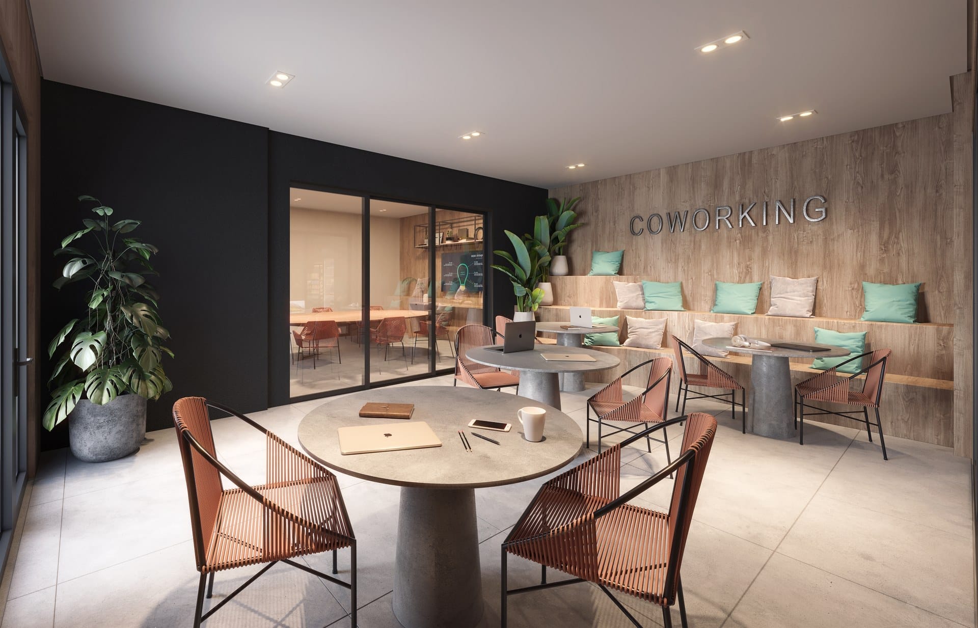 Coworking com mesas compartilhadas, poltronas e integração com o jardim